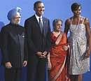 US President Barack Obama and first lady Michelle Obama welcome Prime Minister Manmohan Singh and wife Gursharan Kaur, as they arrive for the G-20. AP