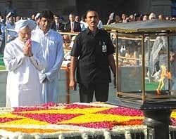 Prime Minister Manmohan Singh pays his respects at Rajghat on Gandhi Jayanti, in New Delhi on Friday. AFP