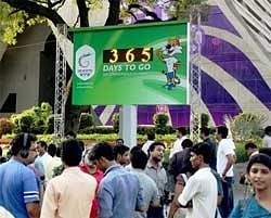People near the XIX Commonwealth Games countdown clock after its inauguration in New Delhi on Saturday. PTI