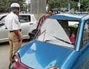An iron rod fell from the metro rail bridge piercing the windshield of a Reva car on MG Road in  Bangalore on Monday. DH Photo