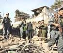 Afghan policemen inspect the site of an explosion in Kabul on Thursday. AFP