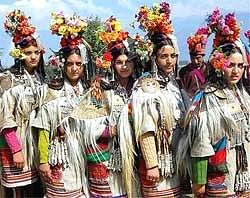 Ladakhi girls, wearing a traditional dress, present a cultural programme during the inaugural function of the Kashmir Festival in Srinagar on Saturday