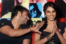 Actor Ajay Devgan shares light moments with actor Bipasha Basu at a promotional event of their upcoming movie 'All The Best' . AP