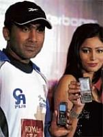 Sri Lankan cricketer Mahela Jayawardena with a model unveiling the Karbonn phones in New Delhi, on Monday AFP