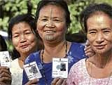 Tribal women show their identity cards as they wait to cast their votes outside a polling booth in Itanagar, Arunachal Pradesh, on Tuesday. PTI