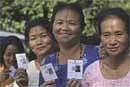 Tribal women show their identity card as they wait to cast their votes outside a polling booth in Itanagar, Arunachal Pradesh. PTI