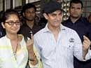 Bollywood actor Aamir Khan along with his wife Kiran coming out after casting votes for the Maharashtra assembly elections, in Mumbai on Tuesday. PTI