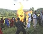 Villagers watch as armed Maoists burn effigies of India's ruling Congress party President Sonia Gandhi, PM Manmoham Singh and Home Minister in Gaya