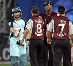 Somerset players congratulate NSW Blues batsmen on their team's 6 wicket victory in a Champions League T20 match in Hyderabad on Sunday. PTI