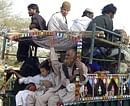 Pakistani tribal families who fled Waziristan, where Pakistan security forces are fighting Taliban militants, arrive at Dera Ismail Khan on Monday. AP
