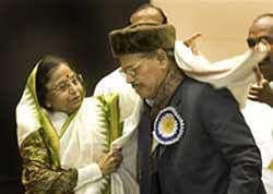 President Pratibha Patil presents a shawl to  Manna Dey, before he was awarded the Dadasaheb Phalke award for the year 2007. AP