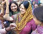 Make merry: Chief Minister Bhupinder Singh Hoodas wife Asha Hooda dances with supporters at their residence in Rohtak on Thursday. PTI