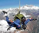 Xyxyxy XyxyxyxY: Skydivers free-fall over Gorakshep on September 21, 2009, during a parachute jump near Mount Everest.