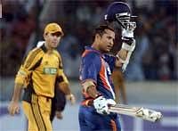 Indian cricketer Sachin Tendulkar after completing a century during the fifth ODI at Hyderabad. Behind him is Ponting. AP