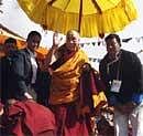 Tibetan spiritual leader the Dalai Lama waves to devotees at prayer meetings, in Tawang, near the frontier with Chinese-controlled Tibet. AP