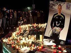 Candles are lit in front of a photo of Germany goalkeeper Robert Enke at a soccer stadium in Hanover, northern Germany, early Wednesday.
