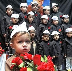 Children pay tribute to Jawaharlal Nehru on the eve of Children's Day, in Bhopal on Friday. PTI