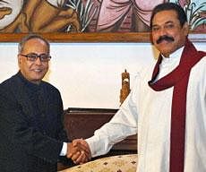 This handout photograph released by the Sri Lankan President's Office shows Sri Lankan President Mahinda Rajapakse (R) shaking hands with Indian Finance Minister Pranab Mukherjee (L) in Colombo on November 15, 2009.