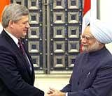 Prime Minister Manmohan Singh shakes hands with his Canadian counterpart Stephen Harper at their joint statement after a meeting at Hyderbad House in New Delhi on Tuesday. PTI