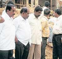 ON duty  MLA K P Bache Gowda reviewing  quality of  concrete road work at Anakanagondi  in Chikkaballapur on Thursday. KMF Director K V Nagaraj and others are seen. dh photo