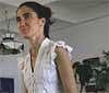 In this April 11, 2008 file photo, Yoani Sanchez, who writes the "Generation Y" blog, walks inside her home in Havana.