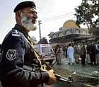 backlash: A Pakistani police officer stands alert after a suicide bombing outside court houses in Peshawar on Thursday, the latest attack in an onslaught by militants fighting back against an army offensive in the nearby Afghan border region. ap photo