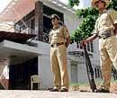 A policeman stands guard at the house of Congress leader Chakrapani at Kodigehalli in Bangalore during the Income Tax department raid on Friday.  DH Photo