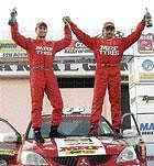 champs Team MRFs Gaurav Gill and Musa Sherif celebrate their victory in the Chikmagalur Rally on Sunday.
