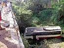 A view of KSRTC bus which fell into a 30-feet deep gorge near Kattehole in Tarikere.