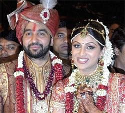 Bollywood actress Shilpa Shetty, right and London based businessman Raj Kundra pose for the media after their marriage ceremony in Khandala around 110 kilometers (69 miles) from Mumbai on Sunday. AP