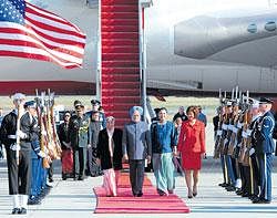 RED CARPET WELCOME: Prime Minister Manmohan Singh, accompanied by wife Gursharan Kaur (left), arrives to a red carpet welcome at the Andrews Air Force Base in Washington on Sunday. DH photo by K N Shanth kumar