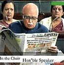 A TV grab shows Leader of the Opposition L K Advani reads a newsaper report on the Liberhan Commission in Lok Sabha on Monday. AP