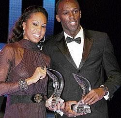 bolt and beautiful: United States Sanya Richards (left) and Jamaican Usain Bolt pose with their spoils at the IAAF gala in Monaco on Sunday. AFP