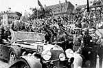 This 1937 picture shows German chancellor Adolf Hitler standing in a convertible Mercedes as he reviews troops and wellwishers in Germany. AFP