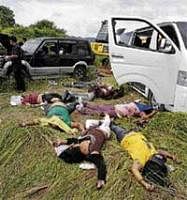 Bodies lie on the ground near their vehicles at the scene of a massacre of a political clan that included several journalists in the outskirts of Ampatuan, Maguindanao, in southern Philippines on Tuesday. Reuters
