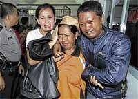 Grief-Stricken People: Relatives of a victim of the ferry mishap weep at Sekupang port in Batam, Indonesia, on Tuesday. AP