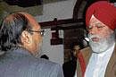 BJP leader S S  Ahluwalia, right, talks with Samajwadi Party leader Amar Singh after tabling of the Liberhan Commission report in Parliament in New Delhi on Tuesday. AP