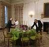 White House staff set up a sample display of a table setting prior to the State Dinner for Indian Prime Minister Manmohan Singh in the State Dining Room of the White House in Washington, Tuesday. AP
