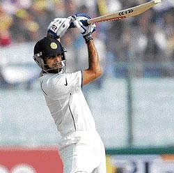 Indian cricketer Rahul Dravid acknowledges the crowd after scoring a century at Kanpur on Wednesday. AP