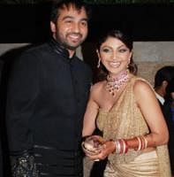 Raj Kundra and his wife Bollywood actress Shilpa Shetty attend a wedding reception in Mumbai on November 24, 2009.