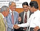 Greetings: Transport Minister R Ashok greets New Delhi Municipal Council former director K C Sharma at a seminar organised by BBMP and Horticulture department in Bangalore on Wednesday. INDAM MD Manmohan Attavar and BBMP  Commissioner Bharat Lal Meena are seen. DH Photo