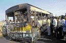Ghastly sight: People look at the charred school bus that caught fire in New Delhi on Thursday. PTI
