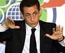 French President Nicolas Sarkozy gestures at a news conference held during the Commonwealth Heads of Government meeting (CHOGM) in Port-of-Spain on Friday. AP