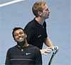 India's Leander Paes, left, and his partner Czech Republic's Lukas Dlouhy react during their ATP World Tour Finals tennis match against Belarus' Max Mirnyi and Israel's Andy Ram in London, Friday.AP