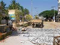Workers demolishing the storm water drain on Double Road in Chintamani. Dh Photo