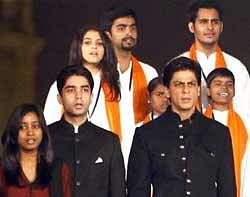 Bollywood actor Shahrukh Khan and Olympic gold medalist Abhinav Bindra sing the national anthem at a programme on the first anniversary of the final day of the seige of 26/11 in Mumbai, in New Delhi on Sunday. PTI
