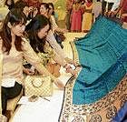 impressed Members of the Sakurakai Japanese Ladies Association looking at the sarees.