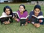engrossed Reshma (extreme left) reads the Twilight series along with her friends.