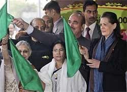 India's ruling UPA chairperson Sonia Gandhi (L), with Railway Minister Mamata Banerjee during the flagging off ceremony of the Red Ribbon express, a train that will travel across the country to spread awareness on HIV and AIDS, marking World AIDS Day, in New Delhi, Tuesday. AP