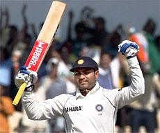 Virender Sehwag celebrates after completing his century on the second day of the third and final test between India and Sri Lanka in Mumbai on Thursday. PTI